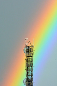 Colorful rainbow hits a communication tower